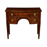 A George IV mahogany break bowfront dressing table, with ebony and boxwood stringing to top, over