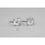 A pair of 18ct white gold and diamond stud earrings, the brilliant cut diamonds totalling