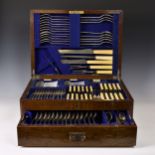 A near complete Walker & Hall silver plated Hanoverian rat tail canteen cutlery, oak cased, of