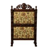 A Victorian carved oak Carolean revival fire screen, the two panel frame carved with foliage,