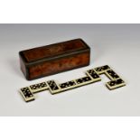 A boxed set of antique bone and ebony backed dominoes by Cremer, c.1860, the rectangular burr wood