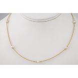 An 18ct yellow gold and pearl necklace, the yellow gold, coil linked chain holding 7 lustrous