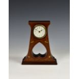 An Art Nouveau walnut and marquetry table clock, c.1905, the white enamel Arabic dial fronting a