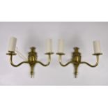 Eight twin branch brass wall lights, with ornate shaped cast backplates, ribbed branches and