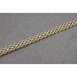 An 18ct gold and diamond gate link bracelet, with alternating yellow and white gold, the white