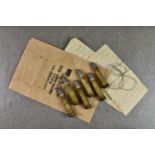 Six .577 Martini-Henry black powder centrefire rifle cartridges with spare packing, each cartridge