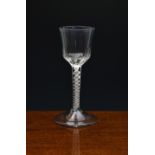 A mid-18th century wrythen moulded airtwist wine glass, c.1760, the ogee bowl with slightly