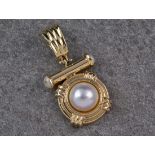 A 14ct gold and cultured pearl pendant, the 10mm. half pearl within a stepped lifebuoy mount,