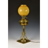 An antique English brass 'Lamp Belge' table lamp, c.1884, converted to electric, with orange /