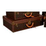 Louis Vuitton - a monogrammed coated canvas and leather hard suitcase, with monogrammed leather