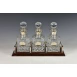 A Elizabeth II silver and cut glass three piece miniature decanter set, S J Rose & Son,