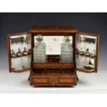 A Victorian Chapmans Patent 12481 oak-cased tantalus & games compendium, the cabinet style box