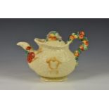 An early 20th century Clarice Cliff ' Celtic Harvest ware' teapot, embossed fruit and wheat sheaf