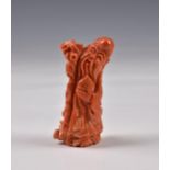 A Chinese carved red coral figure of Shou Lao, 20th century, carrying his gnarled staff in red