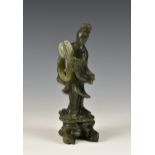 A Chinese carved jade style hardstone figure of Guanyin, second half 20th century, in mottled