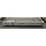 A rare, large Jersey granite pig trough, 18th / early 19th century, finely carved with three