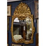 An 18th century style gilt and composition mirror, late 19th / early 20th century, the double c-