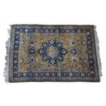 A Persian rug, the royal blue, eight point pendant medallion on a faded madder field with all over