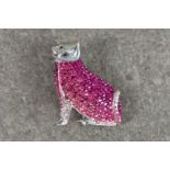 A novelty silver and pink cubic zirconia cat brooch pendant, the seated cat pavé set with