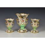 A garniture of three Coalbrookdale style vases, 19th century, encrusted and moulded with flowers,