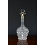 An unusual late Victorian cut glass silver mounted decanter with triple pourer spout, John