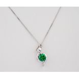 A 9ct white gold and green stone necklace, the pendant stone set in a sweeping, symmetrical design.