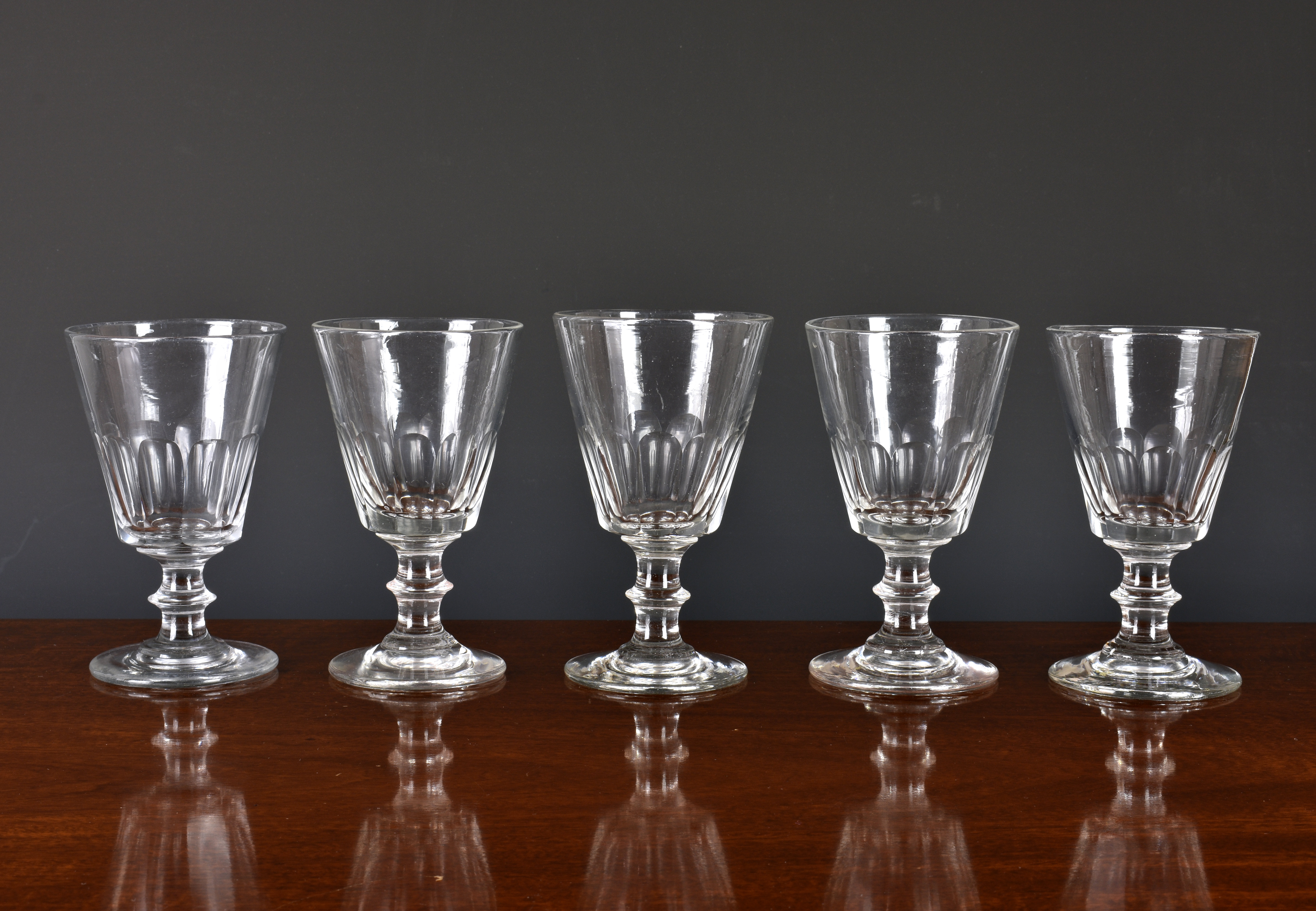 A closely matched set of five 19th century glass rummers, the bucket bowls with panel cut