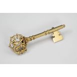 An antique 15ct gold key brooch, with pierced monogram to the terminal, 47mm. long.