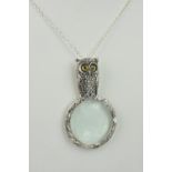 A novelty silver magnifying glass pendant necklace with owl finial, stamped 925, the owl with
