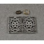 An antique two-piece white metal nurses buckle, of pierced scroll design, with Order of St John star