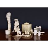 A collection of antique carved ivory objects, including an Indian elephant howdah on ebonised stand;
