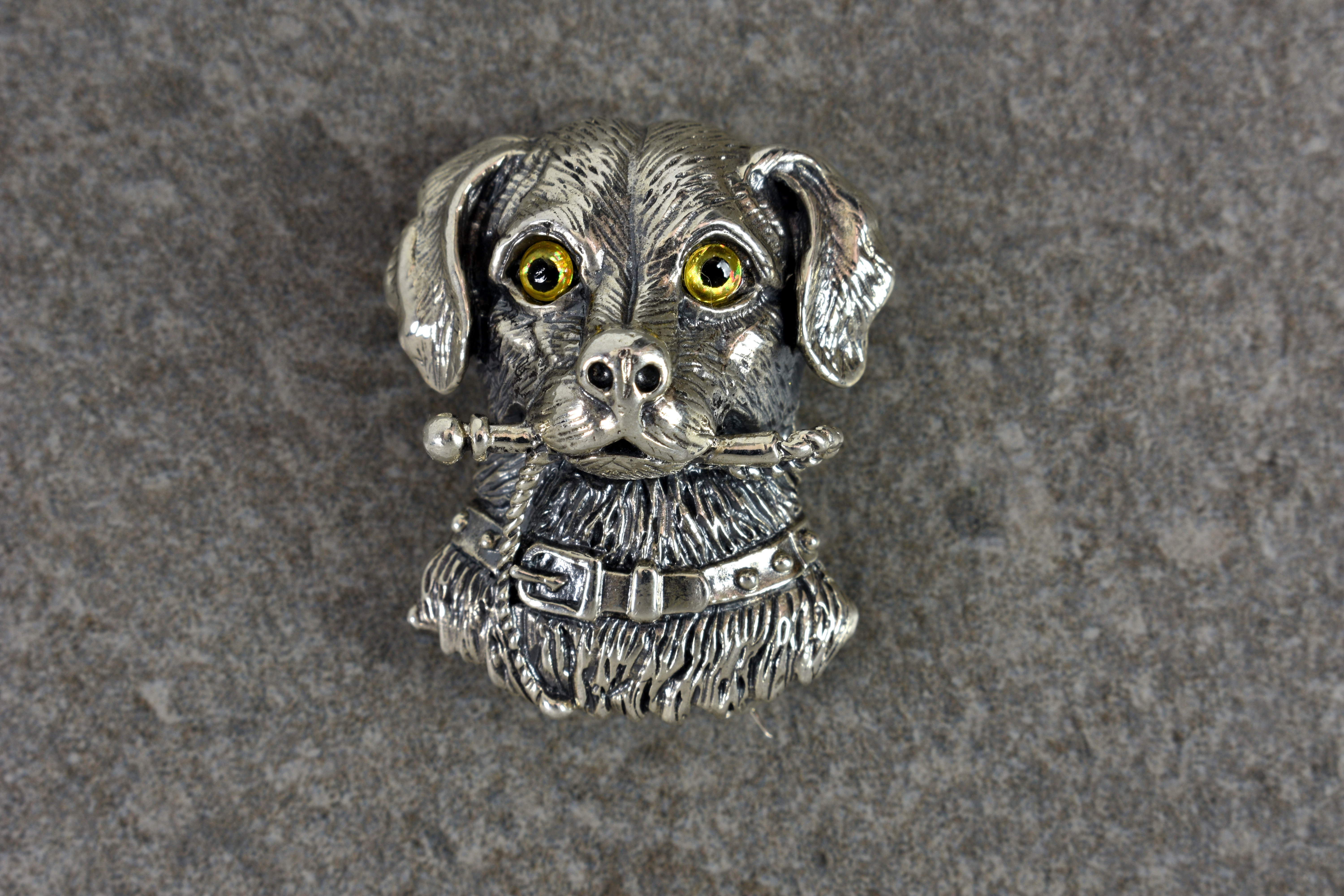 A novelty silver brooch dog pendant, stamped 'Sterling 925', the dog with striking yellow glass