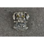 A novelty silver brooch dog pendant, stamped 'Sterling 925', the dog with striking yellow glass