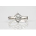 A 9ct white gold and diamond ring, the central, brilliant cut stone weighing approximately 0.15ct