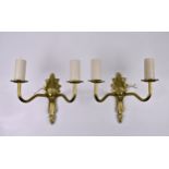 Ten twin branch brass wall lights, with ornate fleur de lys cast backplates, ribbed branches and