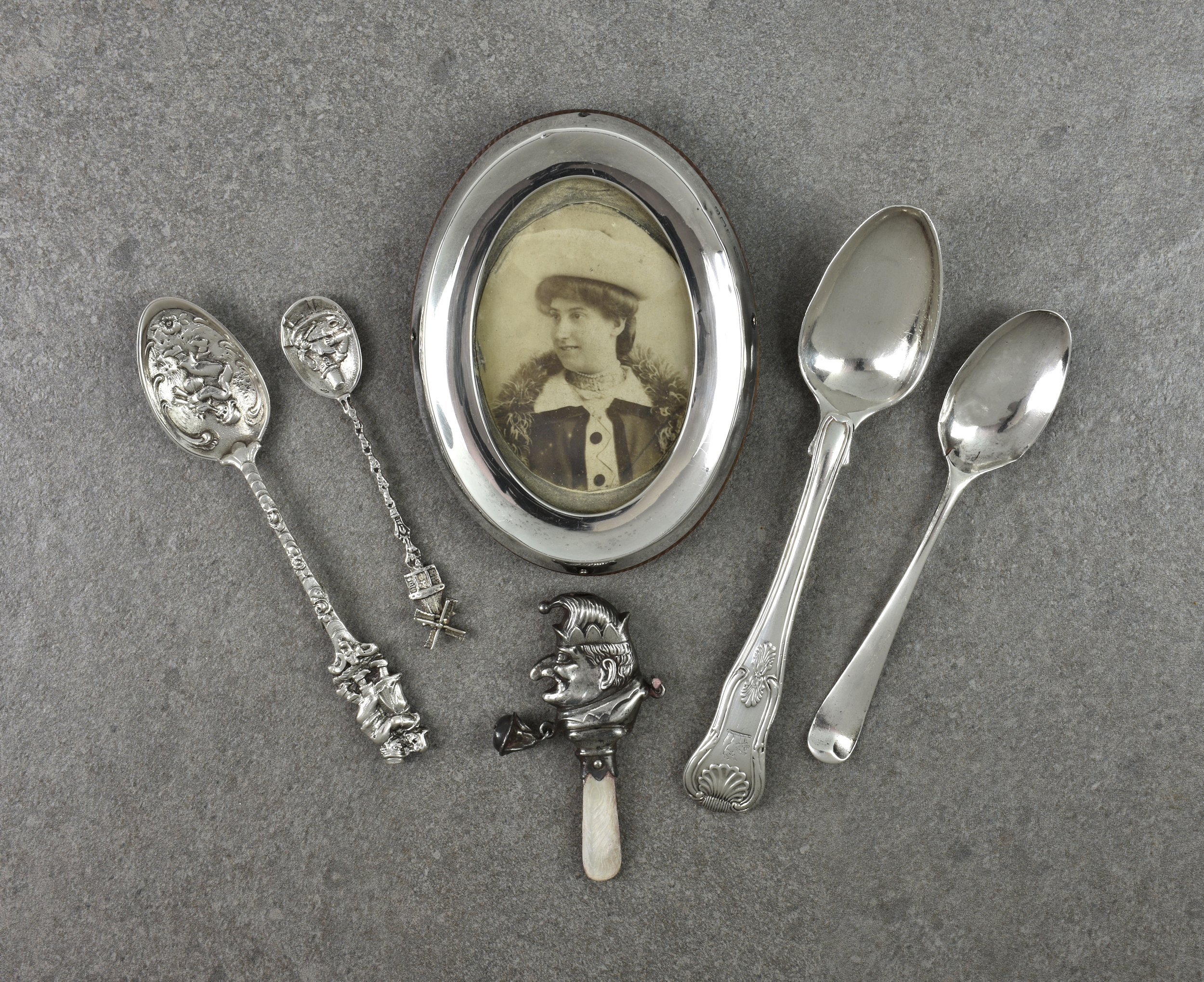 A collection of silver smalls, comprising a Mr Punch childs rattle with mother of pearl teether;