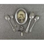 A collection of silver smalls, comprising a Mr Punch childs rattle with mother of pearl teether;
