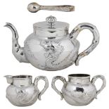 ˜A BOXED CHINESE SILVER THREE-PIECE TEA SET AND SUGAR TONGS, ARTISAN MARK OF HENG LAI,