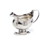 A GEORGE III SILVER MILK JUG, MAKER~S MARK PROBABLY ROBERT & SAMUEL HENNELL OVERSTRIKING ANOTHER, LO