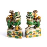 A PAIR OF CHINESE SANCAI GLAZED BUDDHIST LION JOSS STICK HOLDERS, KANGXI PERIOD (1662-1722)