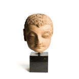 A GANDHARA TERRACOTTA HEAD OF BUDDHA, NORTH-WEST FRONTIER REGION, INDIA (NOW PAKISTAN), 4TH / 5TH CE