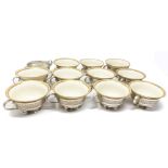 A SET OF TWELVE AMERICAN SILVER CONSOMME HOLDERS, BARBOUR SILVER CO., HARTFORD CT, AND ELEVEN LENOX