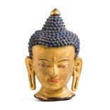 A BRONZE GILT-BRONZE HEAD OF BUDDHA, TIBET, 19TH CENTURY