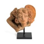 A MAJAPAHIT TERRACOTTA FRAGMENTARY BUST OF A MAIDEN, JAVA, CIRCA 14TH CENTURY