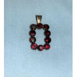 A yellow metal pendant set garnet coloured stones