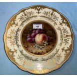 A Coalport cabinet plate with gilt and ivory border, hand painted with fruit in polychrome,