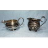 A silver cream jug, Sheffield 1927, 5 oz; another smaller jug, Birmingham 1894, 3 oz