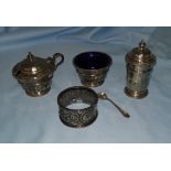 A silver 3 piece cruet set, Birmingham 1931; an embossed silver napkin ring