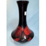 A Moorcroft squat vase with long slender neck decorated in the wisteria pattern under a flambé