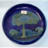 A Moorcroft shallow bowl with everted rim, decorated in the "Moonlit Blue" pattern, impresses and